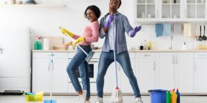 People cleaning there home with a blue broom
